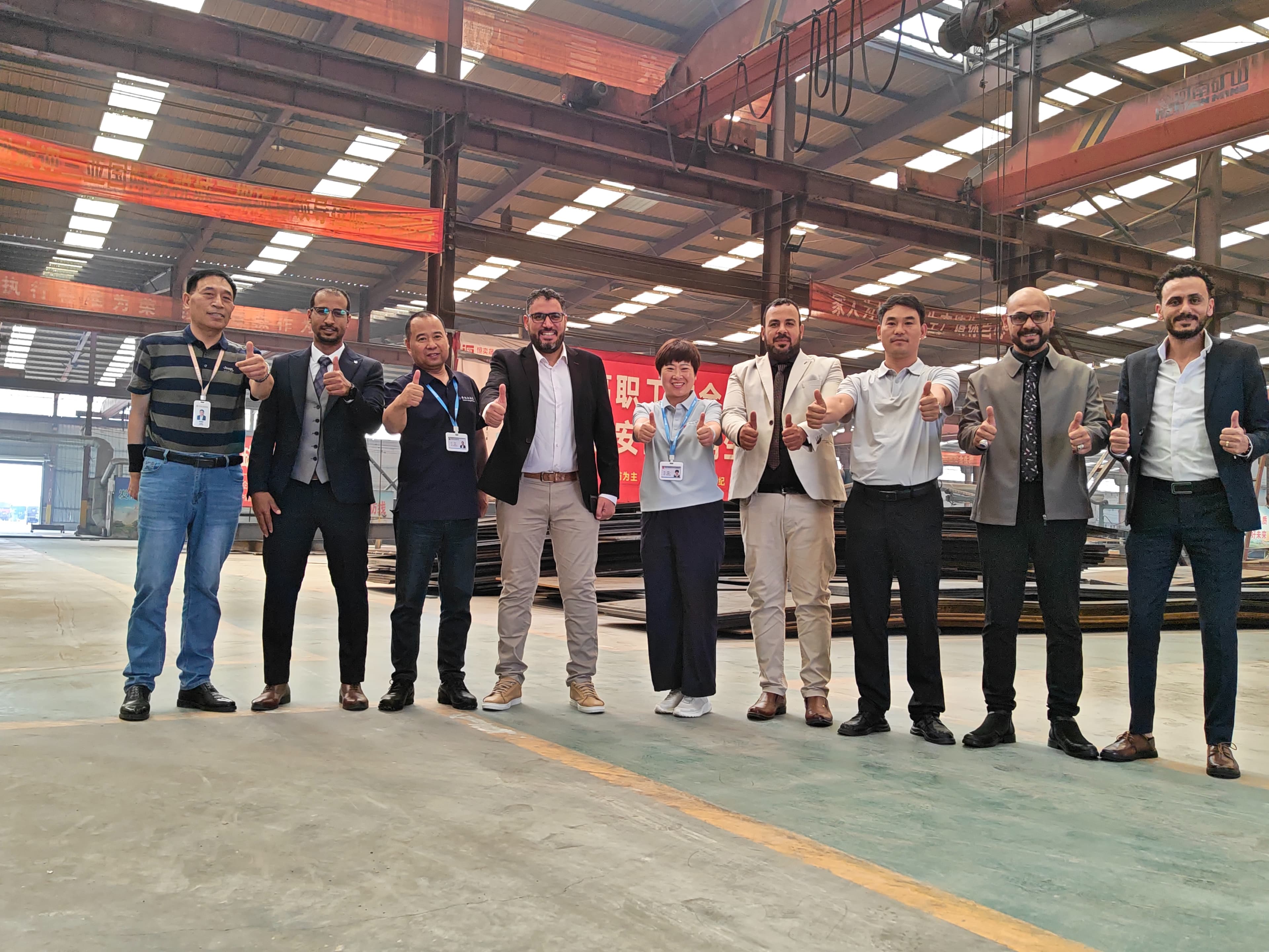 Hengyisheng team welcoming international visitors in the steel fabrication workshop